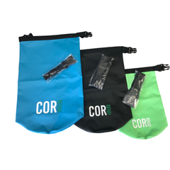 Three COR bags in blue, black, and green with straps on a white background