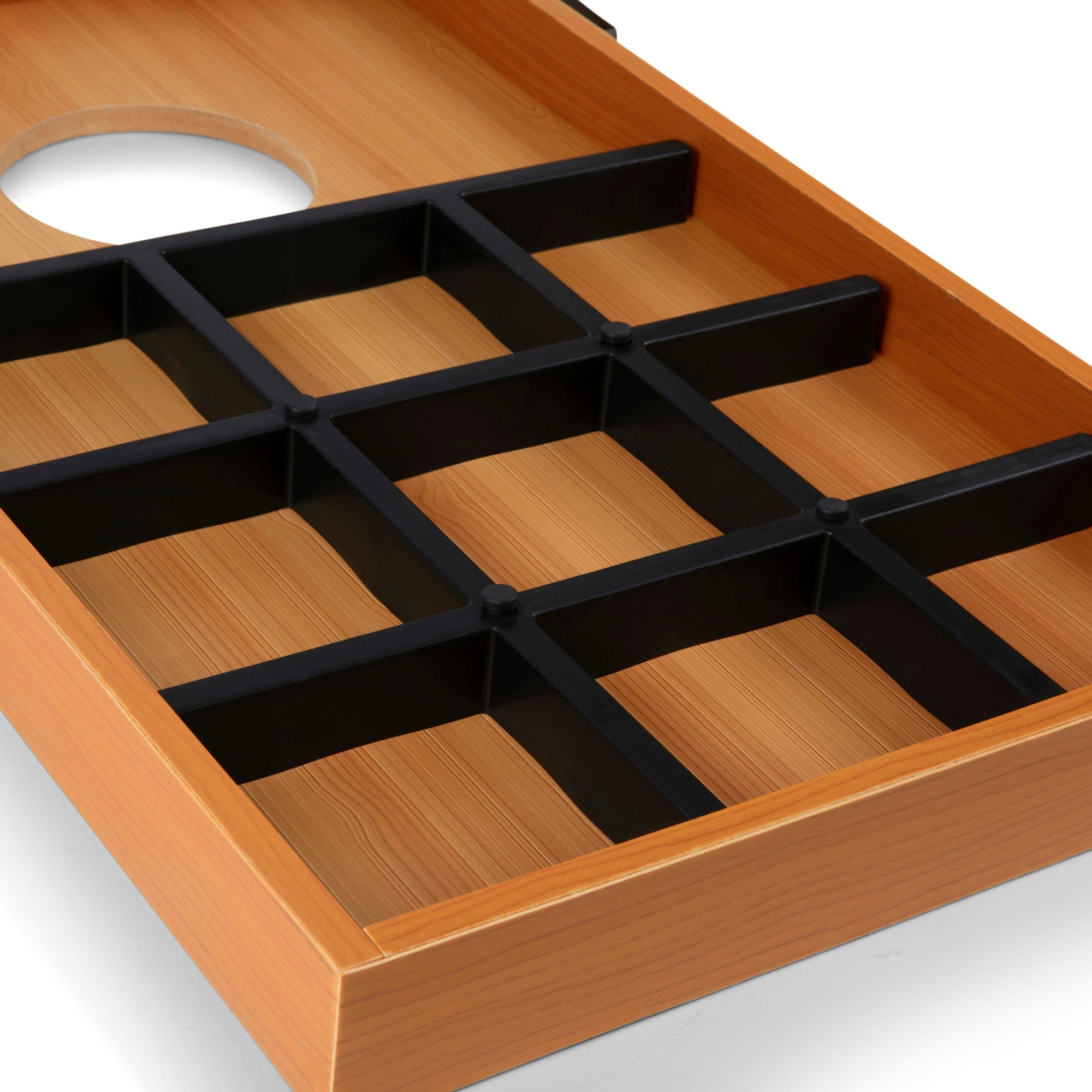 Wooden tray with black compartments on a white background