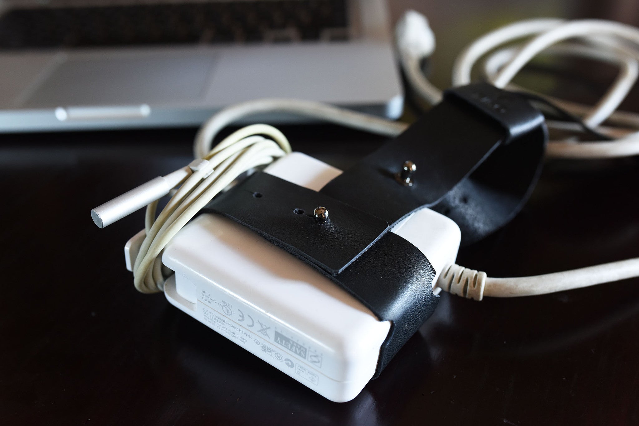Black and white electronic device with cables on a dark surface
