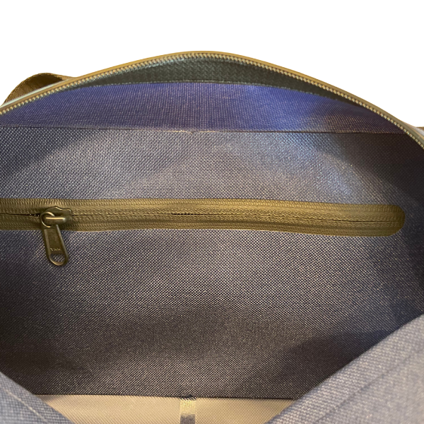 Close-up of a gray bag with a gold zipper on a white background