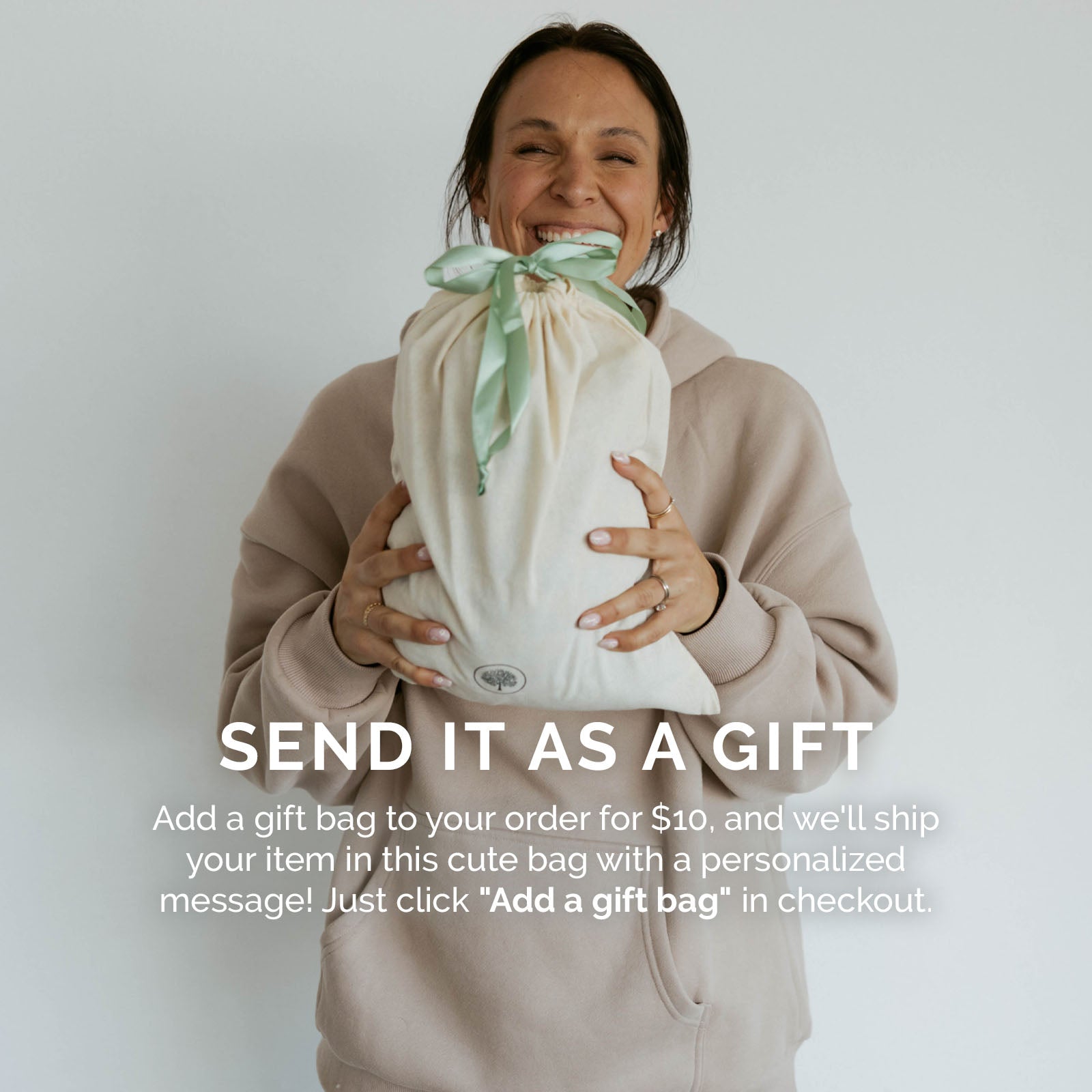 Person holding a gift bag with text about adding a gift bag to orders.