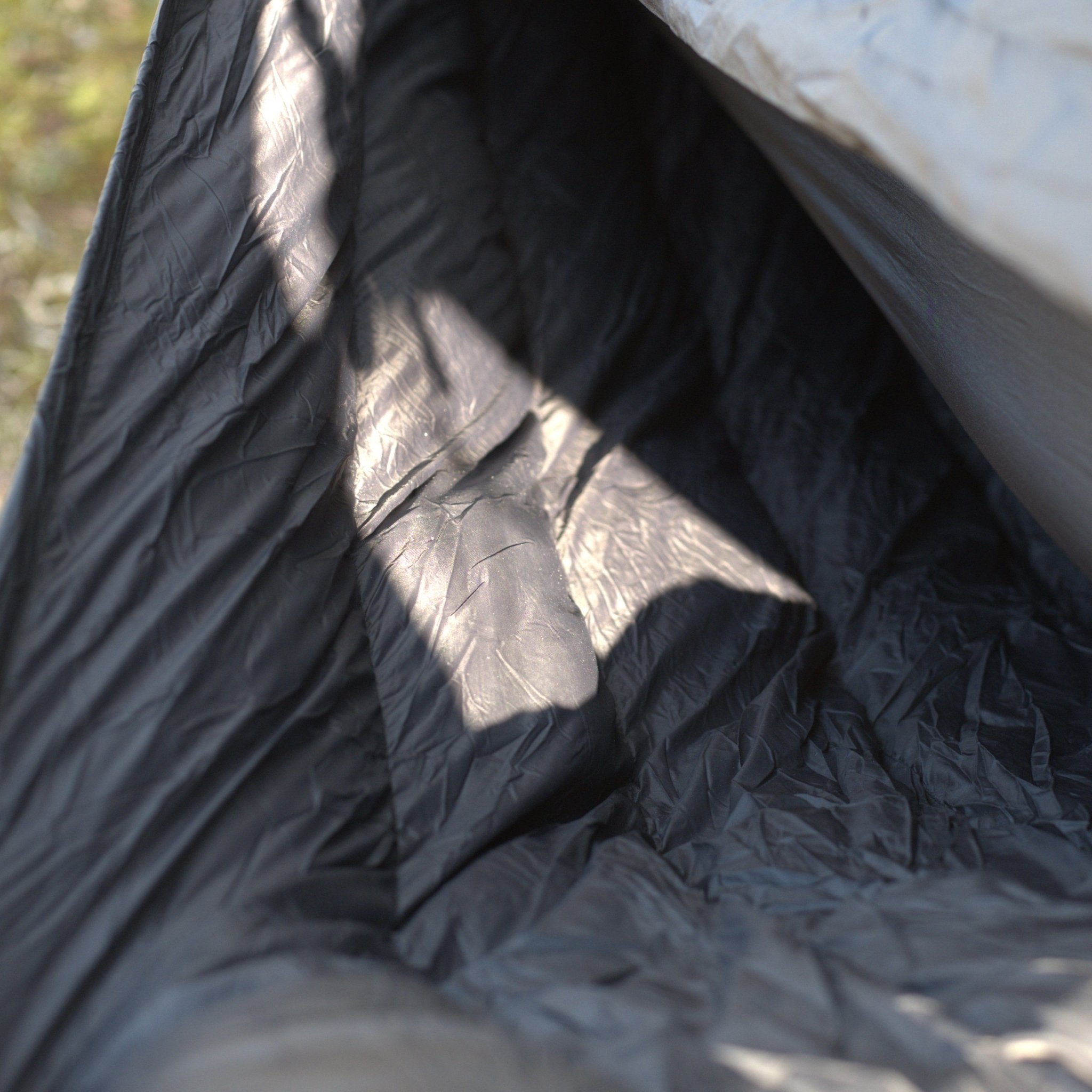 Close-up of a black tarp with folds and textures
