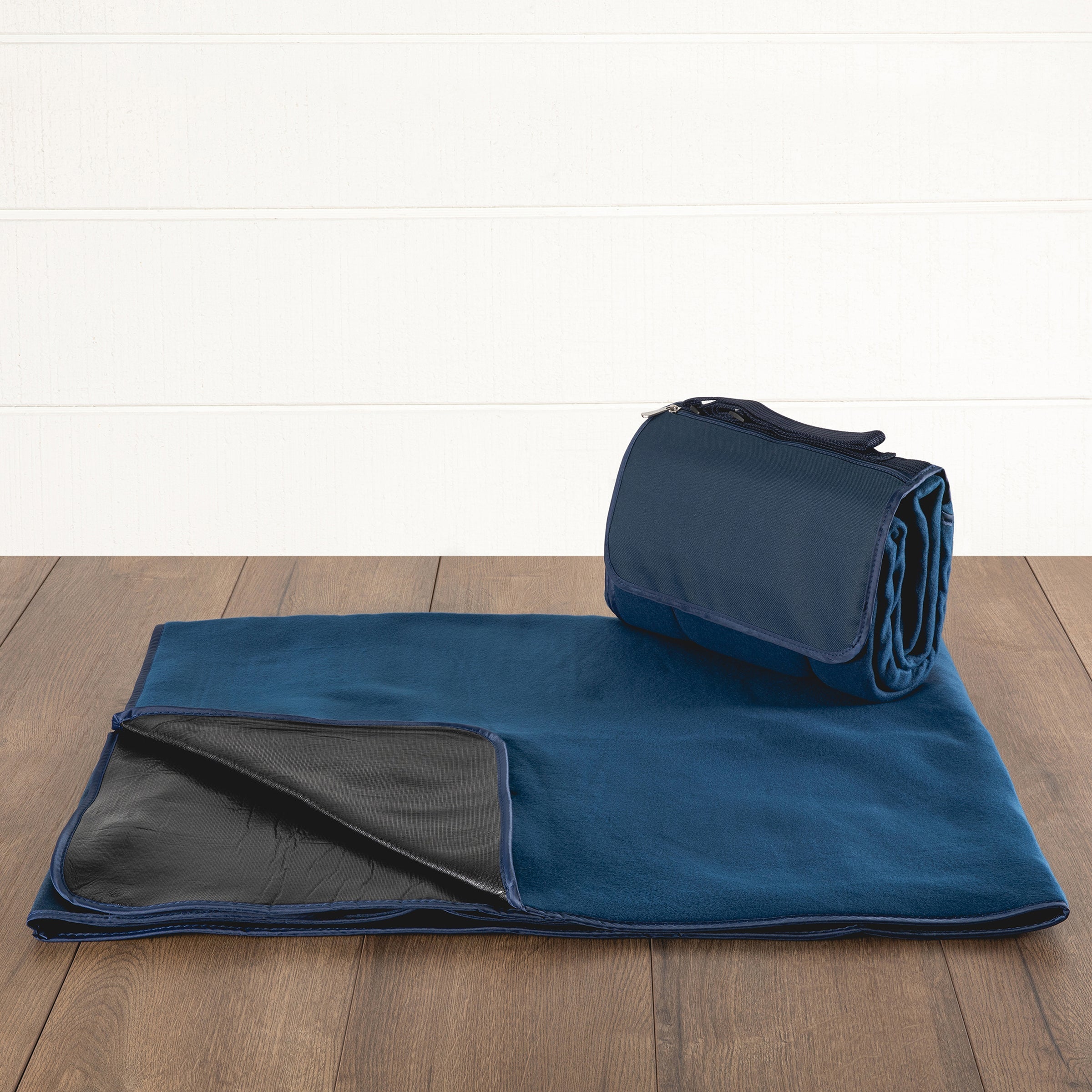 Blue blanket with black lining on a wooden floor