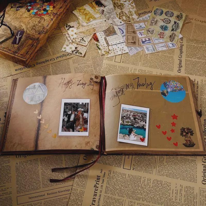 Open scrapbook with photos and decorative elements on a newspaper background