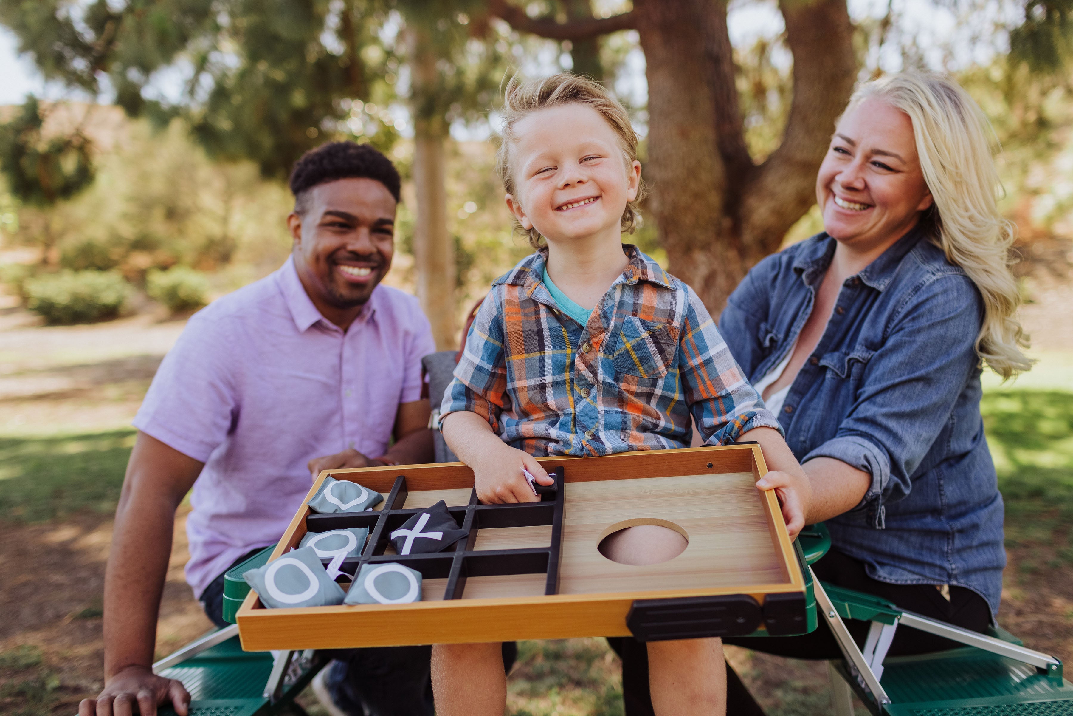 Family playing with a board game outdoors