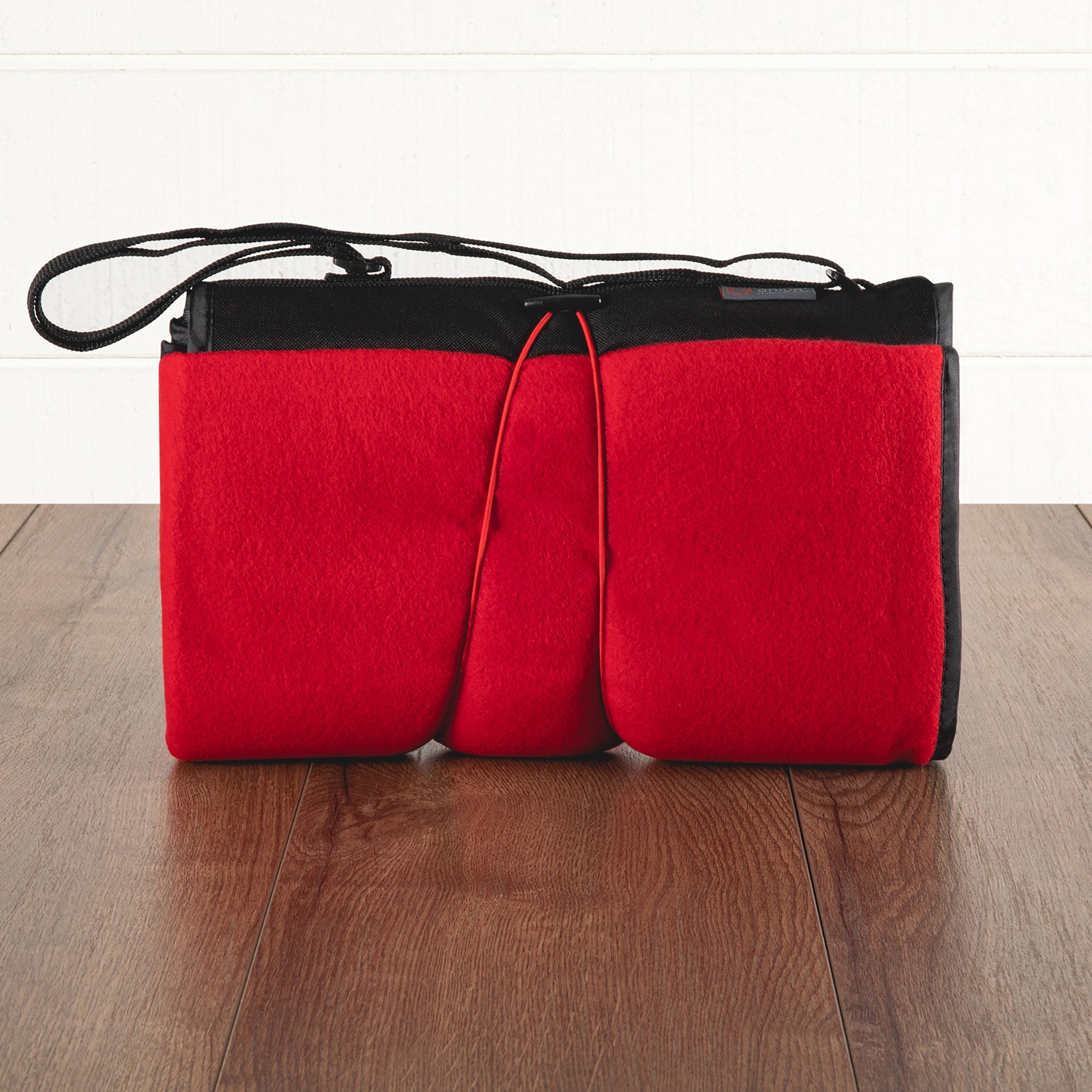 Red and black bag on a wooden surface