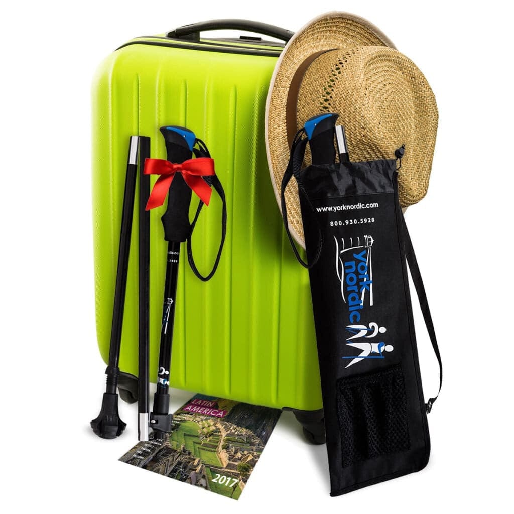 Green suitcase with hiking poles, a hat, and a map on a white background